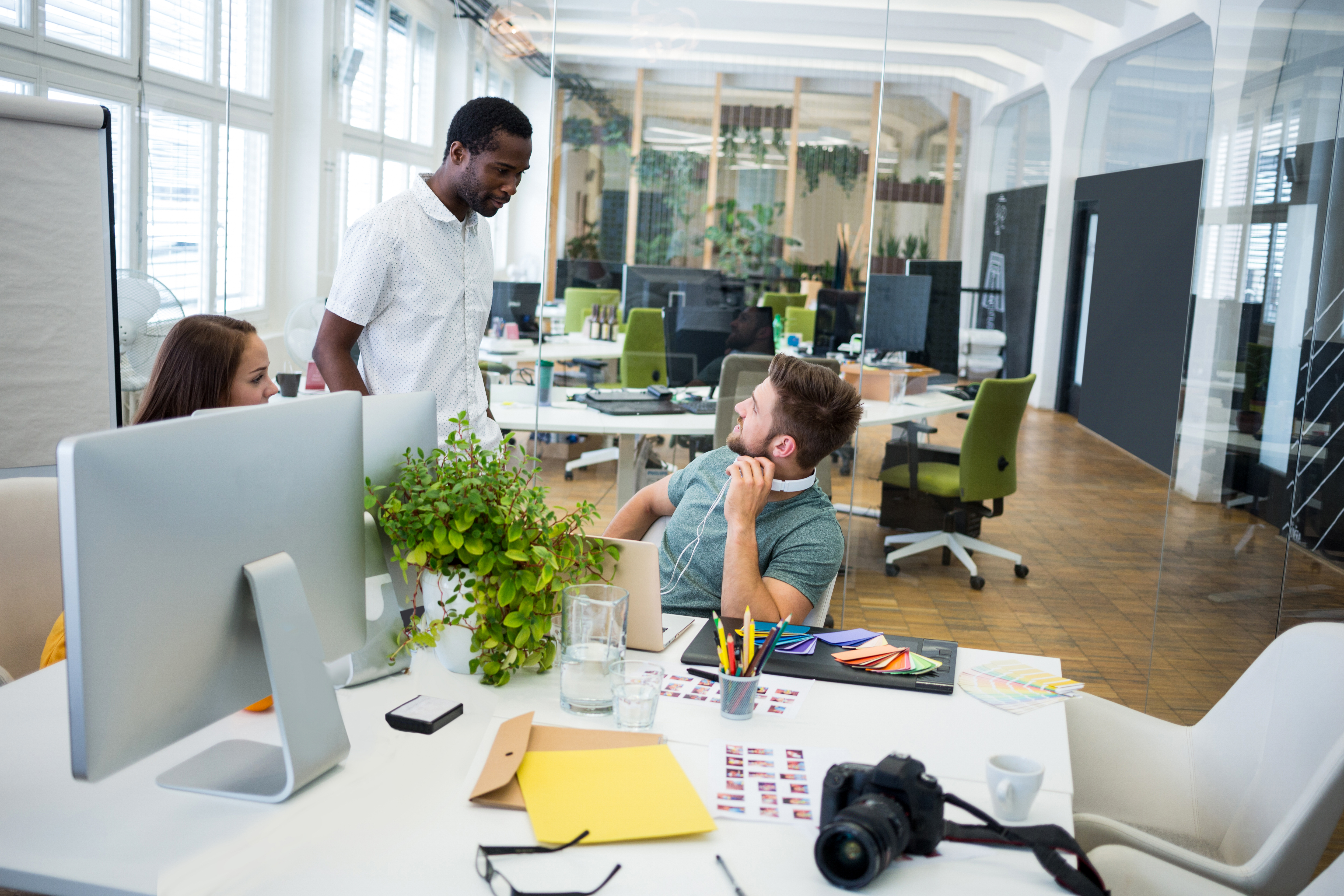 Graphic designers interacting at their desk in office